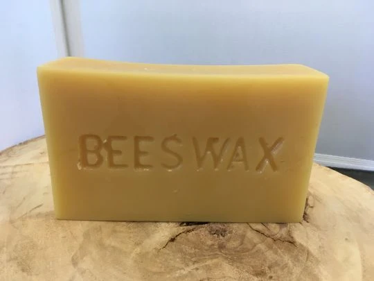 Beeswax block from Y.S. Eco Bee Farms USA being used to make homemade candles