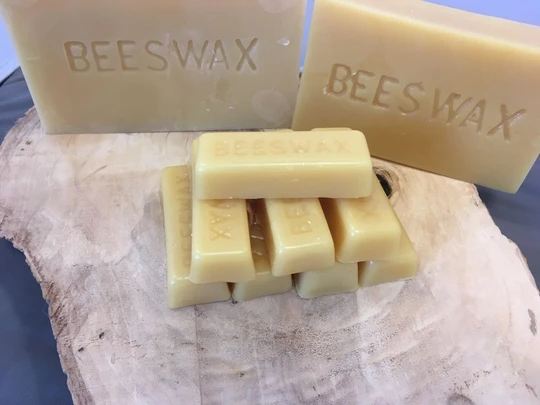 Close-up of pure natural beeswax texture and color from Y.S. Eco Bee Farms USA